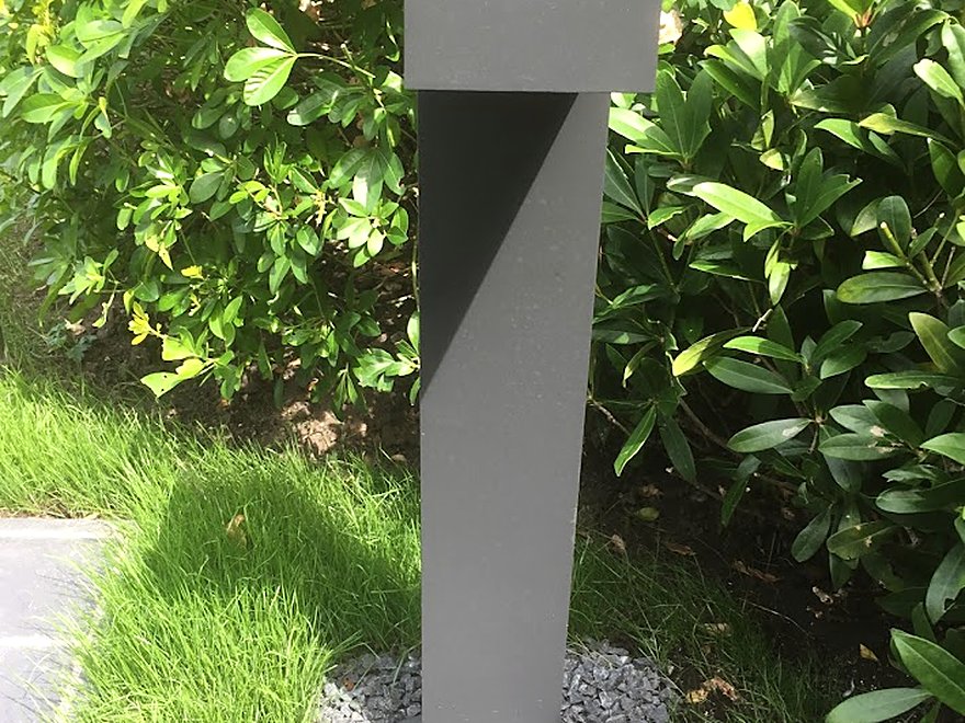 Modern bollard light set into a planted border