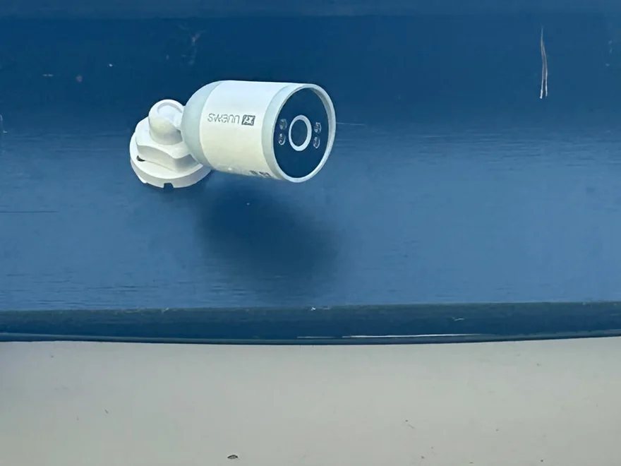 External security camera installed under the eaves of a house