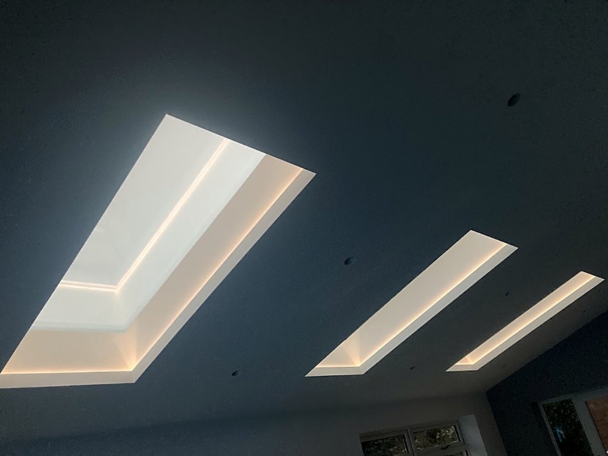 Concealed cove lighting set into a dark vaulted ceiling