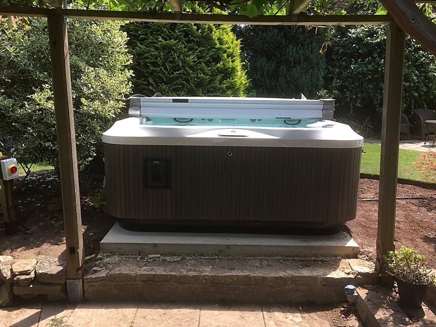 Hot tub installed under a timber pergola with its own electrical supply