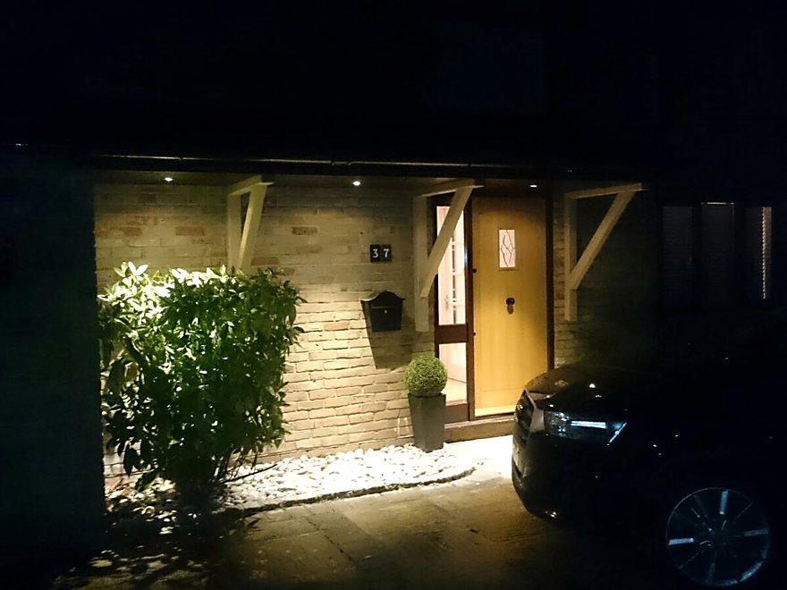 Covered porch and entrance lit at night