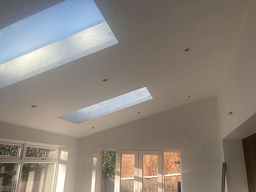Vaulted ceiling with roof lights and recessed downlighting